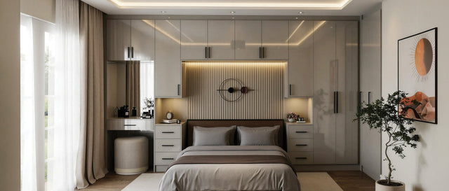 Light grey high-gloss edged fitted wardrobes bridging over a bed with a fluted headboard panel, made to measure in London