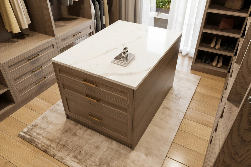 Mayfair island dresser: a freestanding oak-framed island of drawers with a marble top in the centre of a walk-in wardrobe