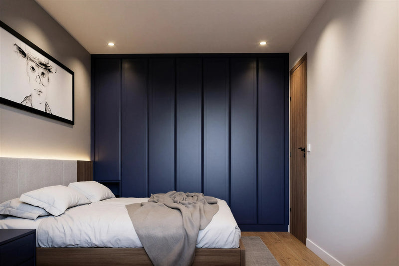 Modern fitted wardrobes around a bed — Oslo doors in deep blue