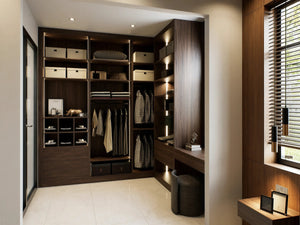 Pelham walk-in wardrobe in London from inside the nook: walnut box shelves, lit hanging, shoe cubbies and drawers, with the dressing desk return under the window. Made to measure by Metro Home Interiors