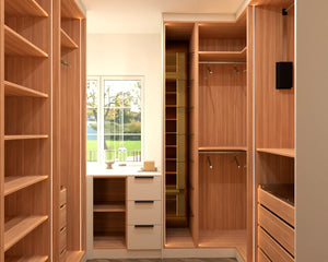 Regents Park walk-in wardrobe in London, fourth view with the doors open: a dressing table under the window between walnut hanging, shelving and drawers. Made to measure by Metro Home Interiors