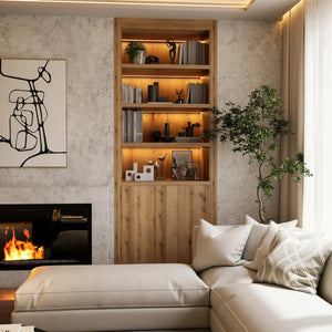 Russell alcove library in London, close up: one oak alcove bookcase with lit shelves of books and objects and a two-door cupboard below, beside the fireplace. Made to measure by Metro Home Interiors