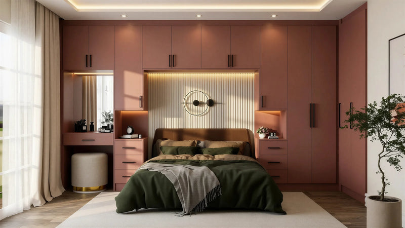 Sandringham over-bed wardrobe in London seen straight on: the full terracotta run from dressing table to far tower with the lit headboard panel between the bedsides. Made to measure by Metro Home Interiors