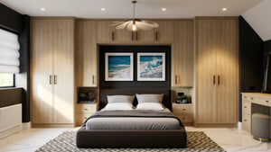 Brooklyn Oak fitted wardrobes in London: natural sanded solid oak Brooklyn Oak doors with black bar handles, wrapping the bed with over-bed storage, bedside chests and a dressing table