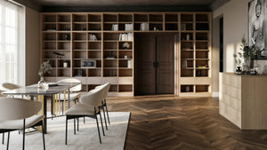Tavistock library wall in London: a floor-to-ceiling open grid of pale oak shelving across a dining room wall and over the doorway, with drawers at the base and a dining table in front. Made to measure by Metro Home Interiors