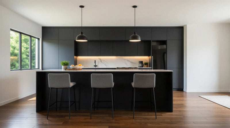 Belgravia matt black island kitchen: a large black island with a white worktop and three grey stools under two pendants, London