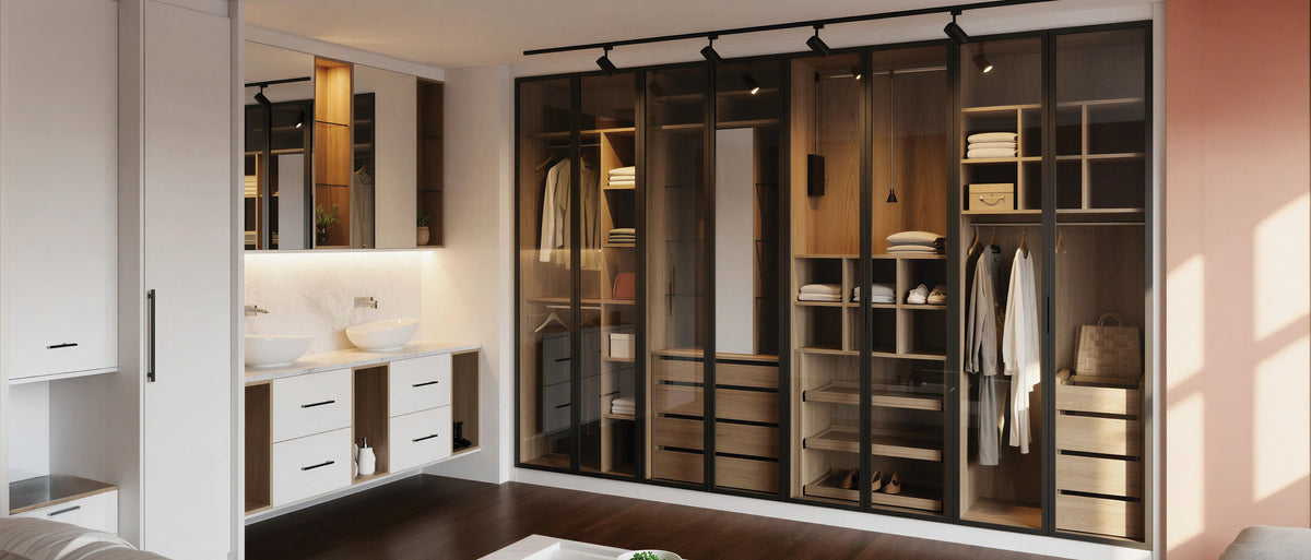 Black-framed glass sliding wardrobe doors over a lit walnut interior beside a vanity, on display at the Metro Home Interiors showroom in Wembley, London