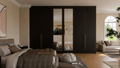 Cordelia fitted bedroom furniture in London: dark walnut sliding wardrobe doors with a mirror panel and brass handles; the walnut sliding wardrobe closed, with its mirror panel and brass handles. Made to measure by Metro Home Interiors
