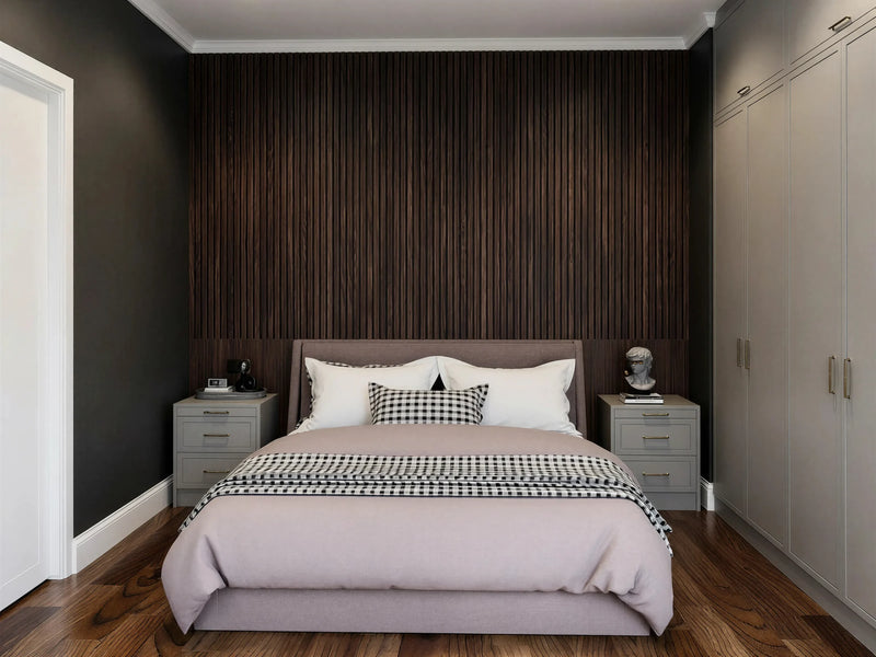 Gladstone MDF painted fitted wardrobe in London: warm grey in-frame slab doors with brass bar handles, wardrobes either side of the bed with matching bedside chests against a dark slatted wall, made to measure by Metro Home Interiors