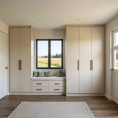 Hampton window seat between two cashmere handleless wardrobes: a cushioned seat over four drawers beneath a bedroom window