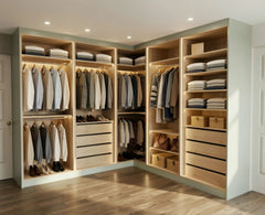 Bespoke walk-in wardrobe with oak interior shelving, hanging space for shirts and jackets, and neatly folded sweaters on shelves
