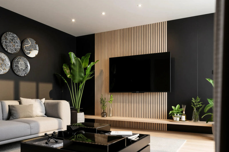Hertford oak slatted TV wall panel in London: a floor-to-ceiling pale oak slat panel set into a charcoal wall, with the television on it and a long floating oak shelf beneath, seen from the sofa. Made to measure by Metro Home Interiors