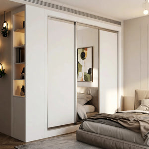 Isadora fitted bedroom furniture in London: cashmere sliding wardrobe doors with a mirror panel, lit open shelving, a fitted desk and a window seat; the sliding wardrobe closed, with its mirror panel and lit shelving beside it. Made to measure by Metro Home Interiors