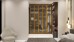 Knightsbridge glass fitted wardrobe in London: champagne aluminium frames with smoked toughened glass over a lit walnut alcove interior, made to measure by Metro Home Interiors