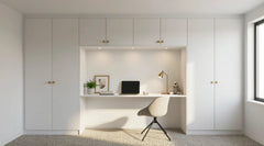 Penelope hinged wardrobe in Pure White with an integrated desk recessed between full-height storage, lit cupboards above and satin brass round knobs, made to measure in London