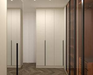 Regents Park walk-in wardrobe in London, third view with the doors closed: cream slab doors with slim black bars and a black framed glass bay showing the walnut inside. Made to measure by Metro Home Interiors