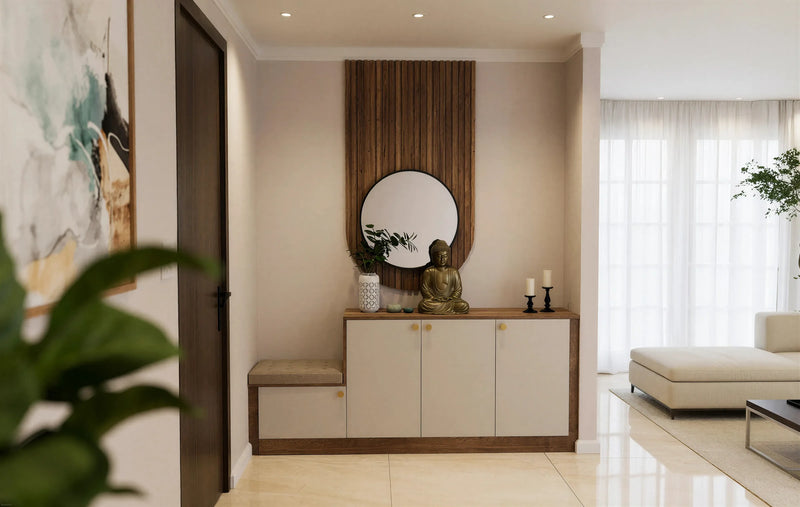Savile fitted foyer unit in London: a low cream slab console with brass knobs on an oak top and plinth, a cushioned bench end, and a walnut slatted panel with a round mirror behind, beside the front door. Made to measure by Metro Home Interiors