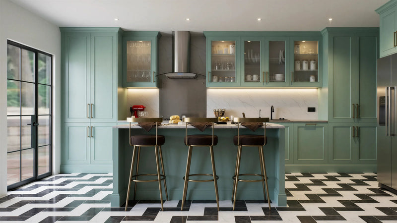 St John's Wood Shaker Island Kitchen in London: sage green in-frame shaker doors with brass handles, a white marble island with breakfast bar, a range cooker and a chevron tiled floor; the island breakfast bar with brass stools and the doors to the garden. Made to measure by Metro Home Interiors