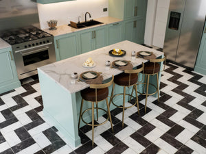 St John's Wood Shaker Island Kitchen in London: sage green in-frame shaker doors with brass handles, a white marble island with breakfast bar, a range cooker and a chevron tiled floor; the marble island top and range cooker from above. Made to measure by Metro Home Interiors
