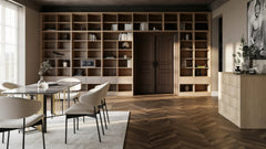Tavistock library wall in London: a floor-to-ceiling open grid of pale oak shelving across a dining room wall and over the doorway, with drawers at the base and a dining table in front. Made to measure by Metro Home Interiors