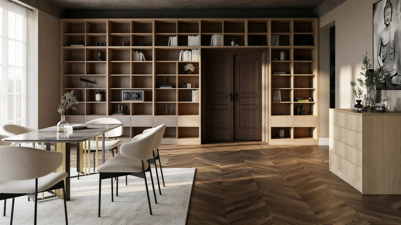 Tavistock library wall in London: a floor-to-ceiling open grid of pale oak shelving across a dining room wall and over the doorway, with drawers at the base and a dining table in front. Made to measure by Metro Home Interiors