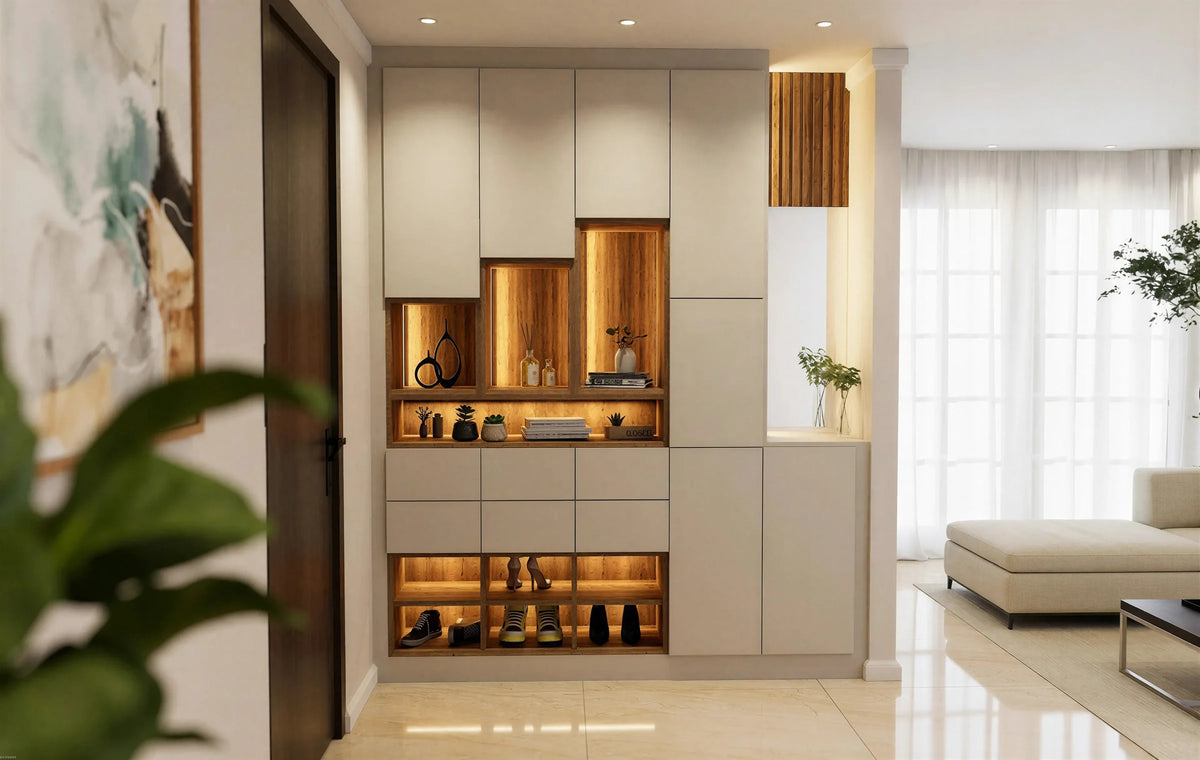 Wilton fitted foyer unit in London: a handleless stone slab hallway wall with three stepped oak-lined niches lit from above, a bank of drawers, an open lit shoe bay and a slatted oak bay with a lit worktop, beside the front door. Made to measure by Metro Home Interiors